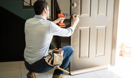 Contractor installing door lock