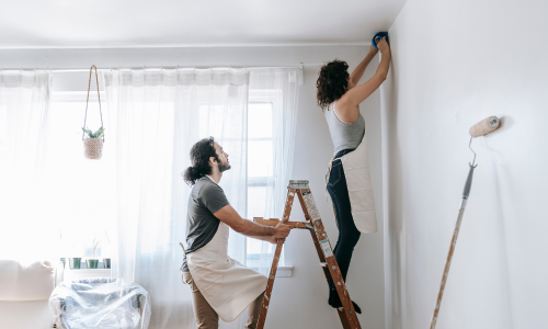 Couple painting an interior room