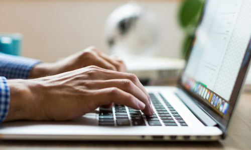 Man typing on laptop